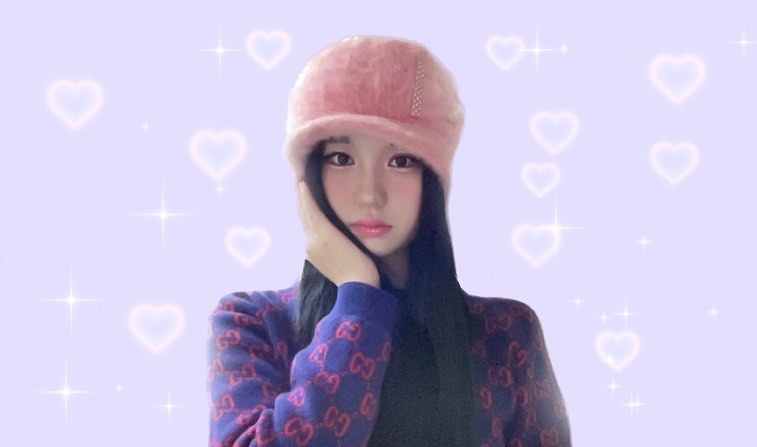 A girl wearing pink fluffy hat