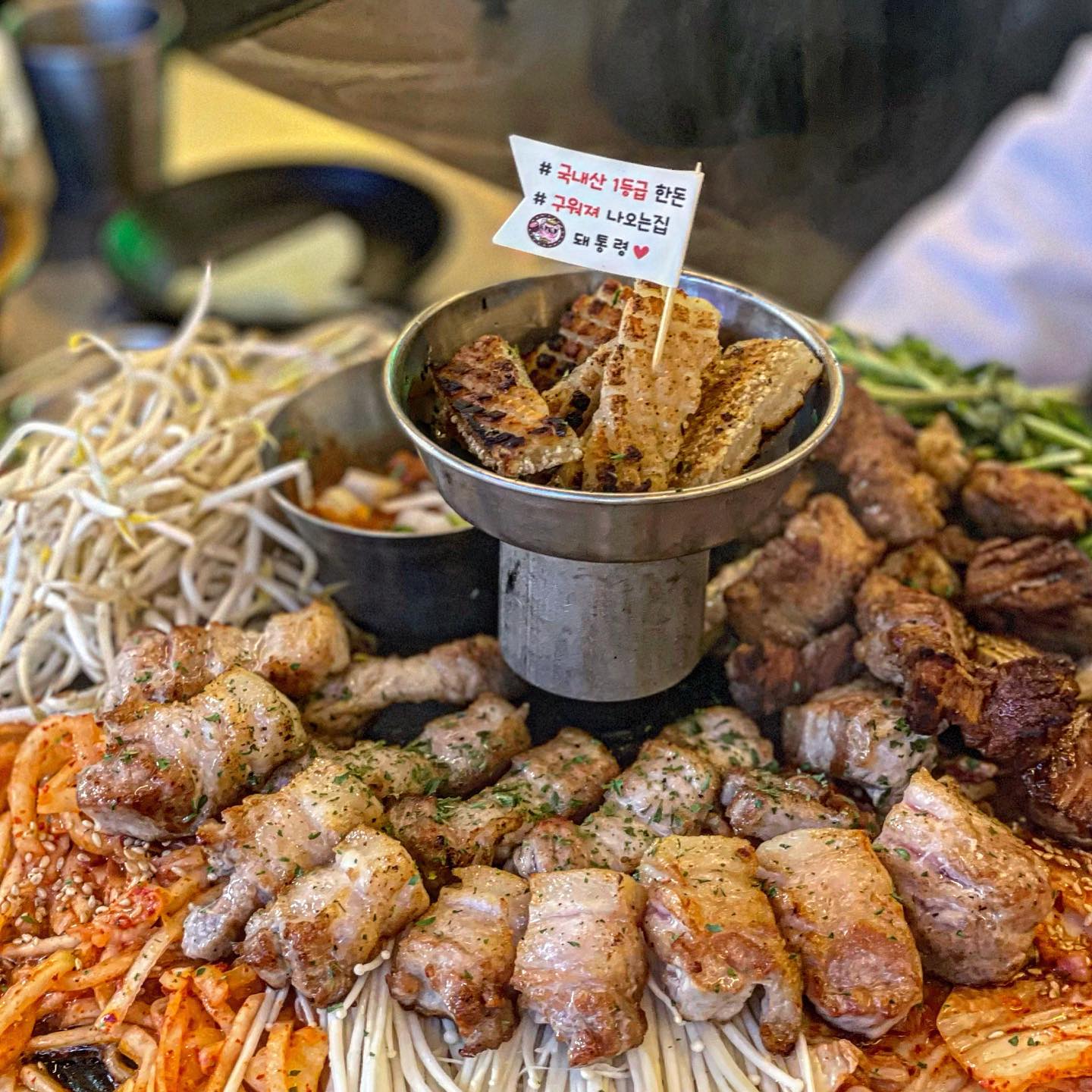 장사의신이 다녀간 그 곳 수원 인계동 #돼통령 🐷

돼통령 수원시청역점은 돼지고기 전문점으로
삼겹살과 목살, 그리고 껍데기가 주요메뉴인 곳이에요 !

기본반찬으로 보글보글 끓는 짜글이가 제공되고,
밑 반찬으로 쌈장과 소금, 쌈무, 콩가루, 소금이 푸짐하게 차려진답니다👍🏻

된장이 묽어보이는데도 연하거나 닝닝하지않고 짭짤하니
고기 먹기전에 입맛을 한껏 돋구워 주는 맛 이었어요🔥

지글지글 다 구워져서 나오는 모둠 한 판은
삼겹살 + 목살 + 껍데기 구성으로

다 구워져서 나오기때문에 술마시면서 손바쁠일 없었답니다💯

숙주, 팽이버섯, 무나물에 가까운 생채, 김치, 콩나물무침,
느타리버섯, 미나리까지 푸짐한 야채구성에다가

이 야채들이 고기 기름에 구워질 수록 더 맛있어지는 맛☺️

쫀득쫀득 껍데기도 콩가루와  잘 어울리고
달달한 마늘소스와 고기의 조합도 찰떡이었어요 :) 💯

가격에 비해 양도 많고, 가성비도 좋으니
회식장소로도 딱일것 같아요! 
수원 나혜석거리 오신다면 돼통령 추천드립니다 :)

📍상호 : 돼통령 인계점
📍주소 : 경기 수원시 팔달구 권광로188번길 41 1층
📍영업시간 : 매일 12:00~22:00
📍메뉴 :  돼통령모듬한판中 (38,000)

#수원맛집추천 #인계동껍데기 #장사의신맛집 
#삼겹살맛집 #돼지고기맛집 #저녁메뉴추천