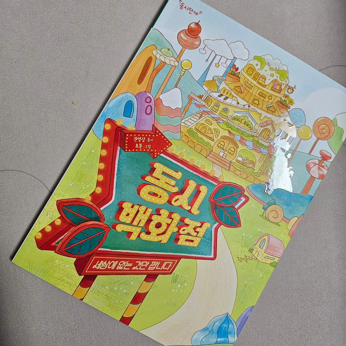 ⁣
우리 꼬마는 자신의 돌잔치 때 “안녕!”이라며 손님들에게 인사를 할 만큼 말이 빠른 아기였다. 감사하게도 지금도 무척이나 다양한 어휘와 표현을 사용하는 소위 '말 예쁘게 하는 아이'로 성장 중이다. 그래서 종종 나에게 비법을 묻는 분들이 있는데, 아무리 생각해도 내가 남들보다 뭔가를 해준 것은 딱 하나뿐이다. 매일매일 목이 터지라고 책 읽어 준 것? 초점 책을 펴놓던 시절부터 동시를 읽어준 것? 그렇다 보니 아이가 듣거나 읽은 동시집이 꽤 많은데, 최근 “가장 재미있는 동시집”이라며 자주 펼쳐보는 시집이 바로 『동시백화점』이다. ⁣
⁣
권영상 시인의 시를 엮은 『동시백화점』은 마음관, 계절관, 곤충관, 잡화관, 하늘공원 등 다섯 가지 주제로 '세상에 없는 것만 파는 백화점'처럼 엮여있어 아이들의 호기심을 자극하고, 더욱 친숙하게 동시를 즐기도록 해준다. 사실 '시'라는 영역은 함축적이고 비유가 많다 보니 첫발을 들이기까지 '어렵다'라고 생각하는 분들이 많다. 아이들도 다르지 않은지 '동시'를 재미없다고 이야기는 경우를 종종 봤다. 그런 점에서 『동시백화점』은 아이들이 더 익숙하고 재미있게 즐길 요소가 많다. 먼저 아이들이 좋아하는 백화점이나 마트의 구조로 되어 있어 친숙할 뿐 아니라, 아기자기한 일러스트가 가득 들어있어 마치 동화책을 읽듯 편안한 접근이 가능하다. 또 사용된 어휘나 표현이 무척 쉽고 간결해 특별히 공부하지 않아도 마치 동요처럼 눈에 쏙쏙 들어오는 문장이 많다. ⁣
⁣
아이가 『동시백화점』에서 가장 재미있어했던 시는 '신장개업'. 사실 신장개업이라는 단어 자체가 요즘 아이들에게는 낯설 수 있지만, 거미가 가게를 열었다는 발상이나 일찍 오지 않으면 소리소문없이 문을 닫는다는 표현이 무척 재미있다고 하더라. 그외에도 'ㅎㅎ'이나 '별사탕'도 귀엽고 재미있다며 여러 번 다시 읽어보기도 했다. ⁣
⁣
엄마가 『동시백화점』에서 가장 마음에 들었던 시는 '오늘을 수선해주세요'였다. 소중한 오늘을 잘 못 사용했다는 말도, 새것처럼 고치고 싶다는 표현도 너무 공감되더라. 우리 모두 한번쯤은 오늘을 다시 살고 싶다거나, 지우개로 지우고 싶다는 등의 표현을 사용해본 적이 있지 않나. 그렇게 수다 떨던 내용을 예쁜 언어로 탄생시킨 느낌이라 더욱 친숙하고 재미있는 시라는 생각이 들었다. ⁣
⁣
동시는 아이들의 언어를 풍성하게 돕는다. 함축성과 비유, 운율 등이 아이의 말을 더욱 노래처럼 만들어준다. 더불어 세상을 더 예쁜 눈으로 바라보게 한다. 『동시백화점』을 읽으면서도 수많은 표현에 감탄하고, 모르던 단어를 새로이 익히는 등 순간순간이 학습이었다. 좋은 건 알겠지만 왠지 시는 어려울 것 같다고? 아니다, 그저 가사처럼 즐기면 된다. 동요를 부르듯 받아들이면 된다. 제목을 말해주지 않고 시를 읽어준 뒤 제목을 맞춰보기도 하고, 읽은 시를 몸이나 그림으로 표현해보기도 하다 보면 아이는 저절로 시를 즐기게 될 것이다. 비슷한 주제로 시를 써보면, 언젠가 우리 아이도 멋진 작품을 탄생시키게 될 것이다. ⁣
⁣
⁣
동시의 장점은 알지만, 엄마·아빠가 어색해서 아이에게도 동시를 읽어볼 기회를 주지 않으셨다면 『동시백화점』을 통해 첫발을 들여보면 어떨까? 세상에 없는 모든 것, 세상에 있었으면 하는 동시가 가득 담겨있으니, 천천히 둘러보면 마음에 드는 동시하나를 그저 고르면 된다.